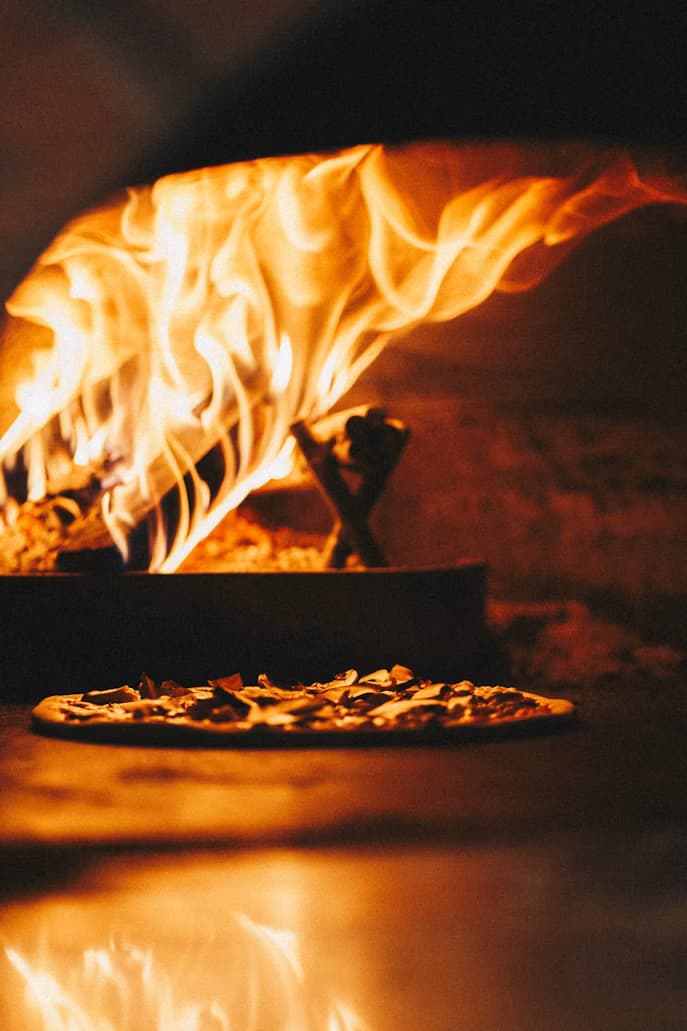 Pizza baking in the wood oven